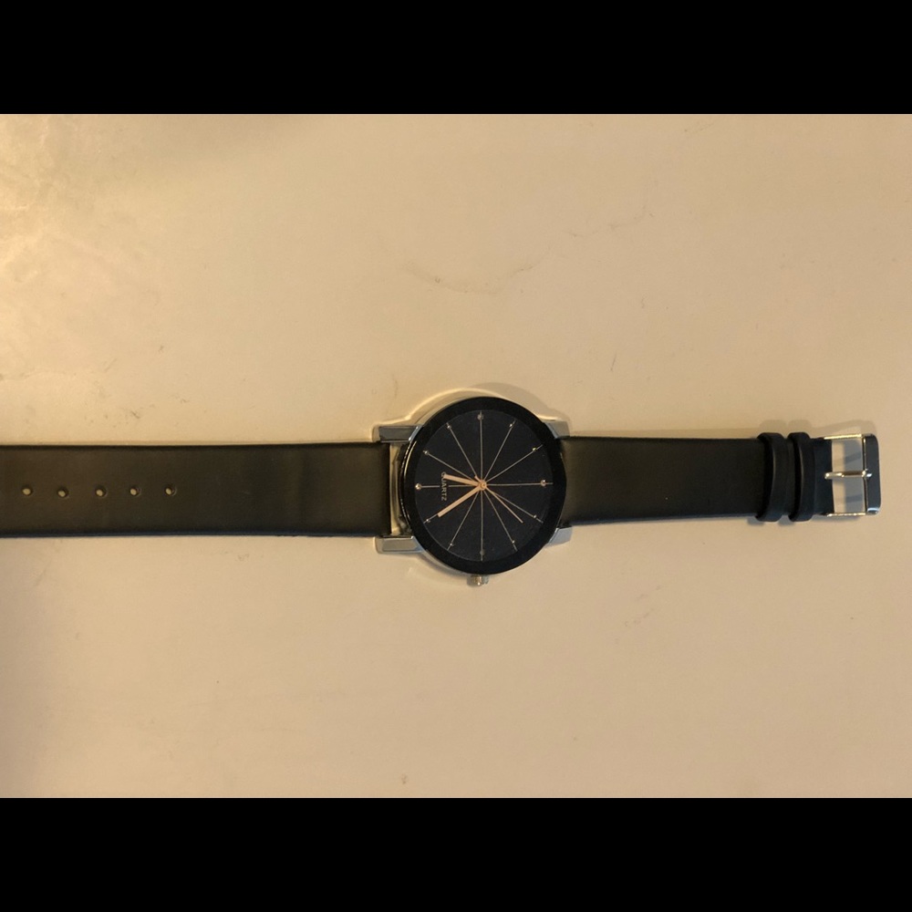 Black wrist watch with gold hands
